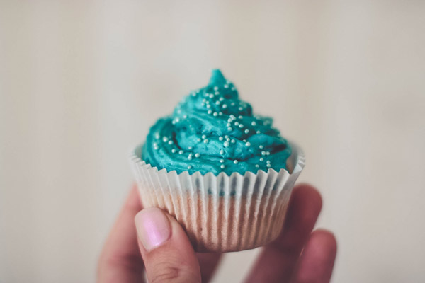 Cupcake With Teal Icing and Sprinkles